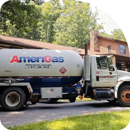 An Amerigas propane delivery truck is parked in front of a house.