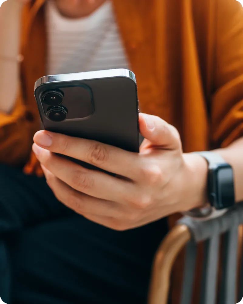 User looking at phone to know more about multi factor authentication