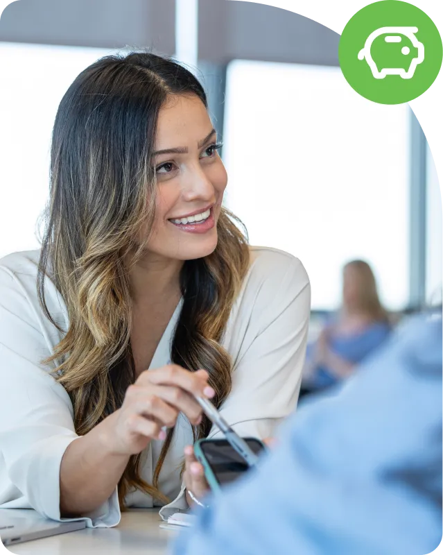 Woman smiling while talking to a colleague about financial solutions