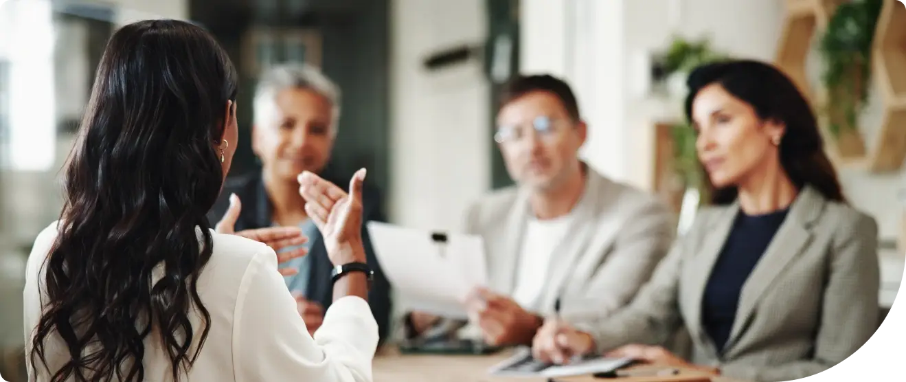 A group of IT professionals discussing their Duo identity and access management strategies to avoid cyber risks.