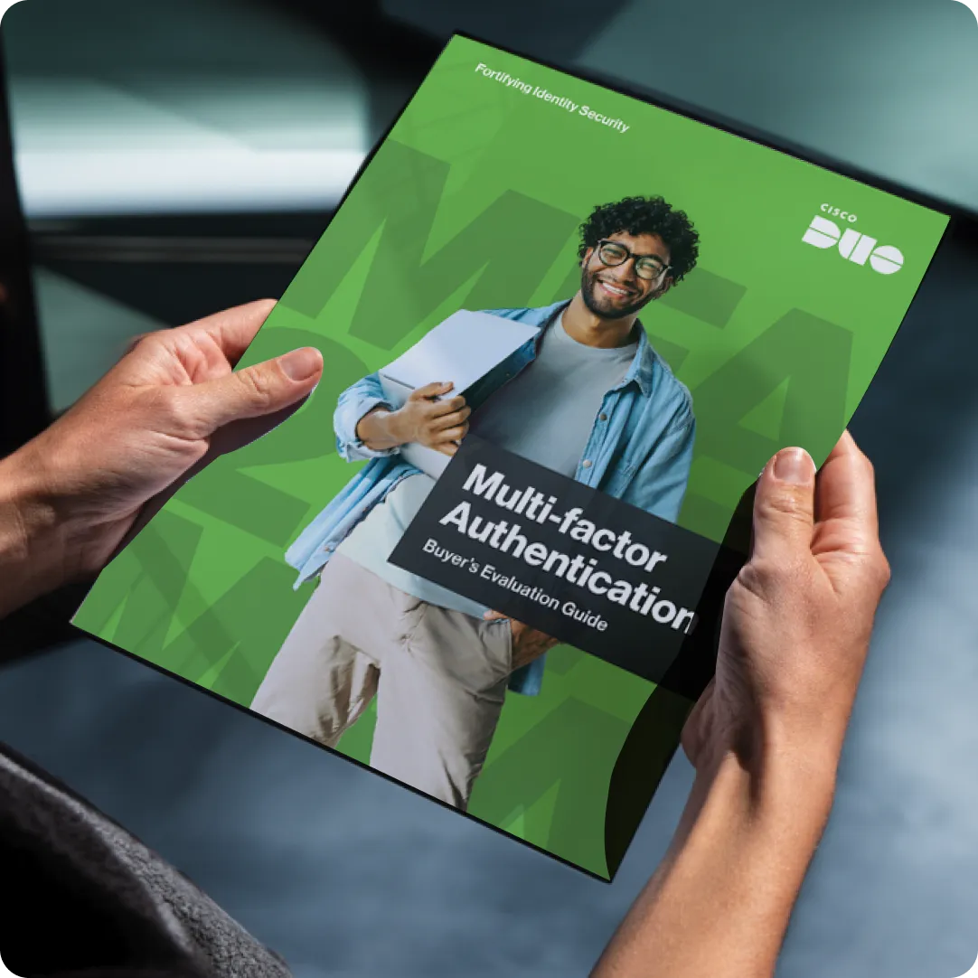 Duo's eBook for the Multi-factor Authentication Buyer's Evaluation Guide being held by a person in an office.
