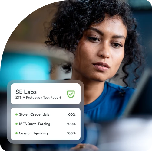 A cybersecurity person looking at a display of the results of a ZTNA protection test report showing complete detection and prevention of identity attacks using stolen credentials, MFA brute-forcing, and session hijacking in testing by SE Labs.
